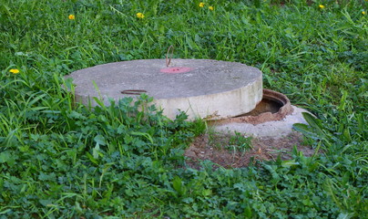 Open the manhole in the grass