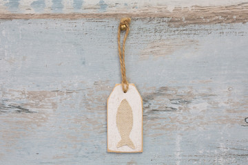 Fish Tag On Distressed Wood Background