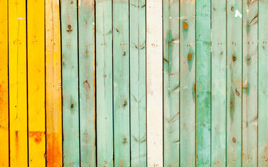 old wooden old fence of greenish blue and orange colors. Can be used as background