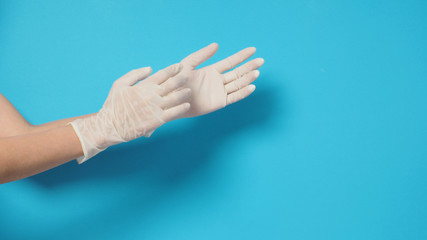 Two hand wearing white gloves and right hand is pulling.Put on blue background.