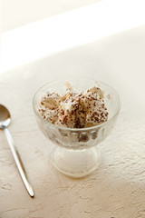 whipped cream dessert with grated chocolate in a glass bowl