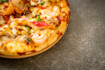 seafood pizza on wood tray
