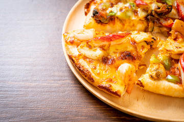 seafood pizza on wood tray
