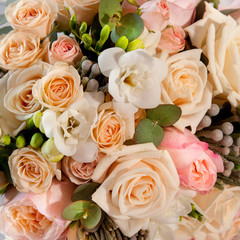 wedding bouquet with pink and tea rose bush and white freesia