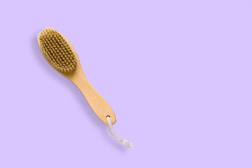 top view brush for dry skin massage on a pastel violet background,copy space