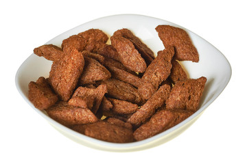 Full bowl of spicy hard chuck from brown bread isolated on white background