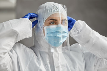 health safety, medicine and pandemic concept - close up of female doctor or scientist in protective...