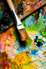 Fototapeta premium A real brush on the background of oil paints