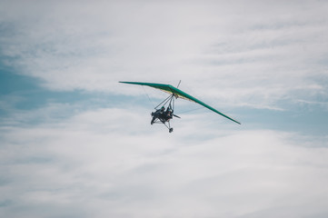 Fototapeta na wymiar The motorized hang glider in the blue sky.