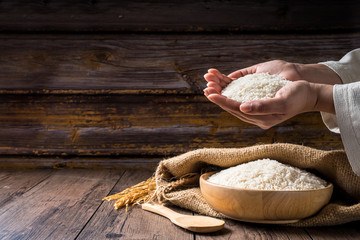 Hands are holding a pile of grain to zakat, Islamic zakat concept. Muslims to help the poor and needy. Conceptual shoot for property, income, and fitrah zakat.