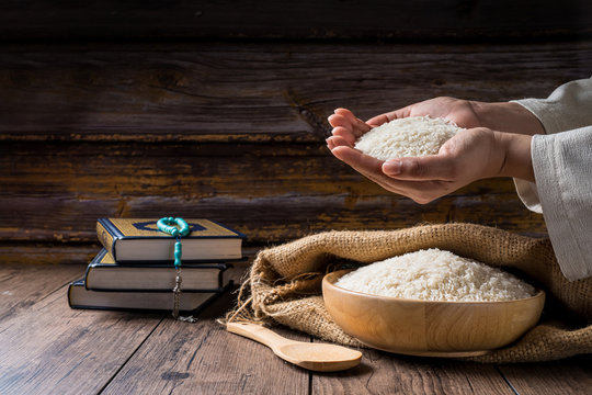 Hands are holding a pile of grain to zakat, Islamic zakat concept. Muslims to help the poor and needy. Conceptual shoot for property, income, and fitrah zakat.