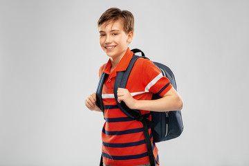 school, education and people concept - smiling student boy with backpack over grey background