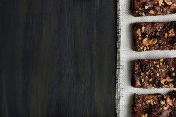 pieces of chocolate brownie on white scarf on the right side in the foreground