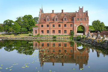Obraz premium Egeskov Castle is located near Kværndrup, in the south of the island of Funen, Denmark. The castle is Europe's best preserved Renaissance water castle.