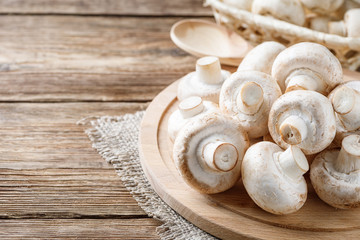 Fototapeta na wymiar Fresh mushrooms champignon mushrooms on a wooden table.