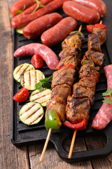 pork meat and sausage on grill