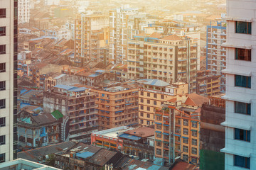 01/22/2020 Yangon, Myanmar (Burma), Aerial shot, view from the drone on the downtovn of Yangon with tiled and moss-covered houses at sunset pop colors. Yangon - the ancient capital of Burma