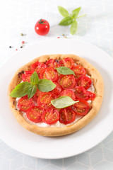 plate of tomato quiche with basil