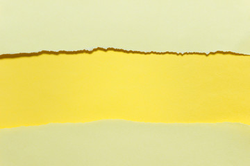 Sheets of yellow paper with ripped edges and wide empty blank copy space.