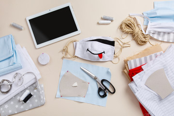 Sewing black & white funny anti-virus mask. Homemade mask with smile. DIY face mask for safety at pandemic or quarantine. Zero waste handmade cotton natural mask against infection. Smile & stay safe