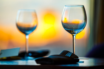 Empty wine glasses on the table against the background of the evening city