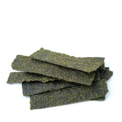 Close-up of Crispy dried seaweed, Nori chips piece of roasted seaweed sheet isolated on white background, macro or close-up Healthy food concept, flat lay roasted seaweed © ric