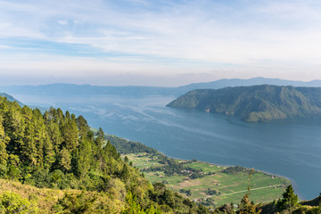 View from the island of Samosir to Lake Toba, the largest volcanic lake in the world situated in the middle of the northern part of the island of Sumatra in Indonesia
