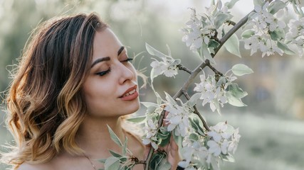 beautiful girl dreams of blossoming apple tree