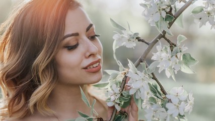 beautiful girl dreams of blossoming apple tree