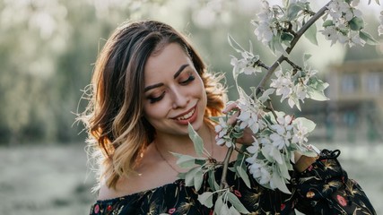 beautiful girl dreams of blossoming apple tree