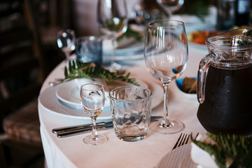 Tables set for an event party or wedding reception. luxury elegant table setting dinner in a restaurant. glasses and dishes.