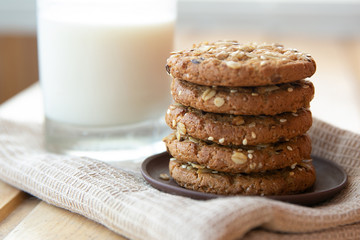 Fototapeta na wymiar oatmeal cookies with a glass of milk on a wooden table
