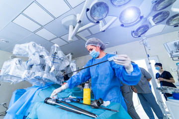 Team surgeon at work in operating room. Modern surgical system. Medical robot. Da Vinci Surgery.