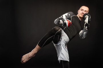 Fototapeta na wymiar Mixed Martial Arts Fighter Against Dark Background