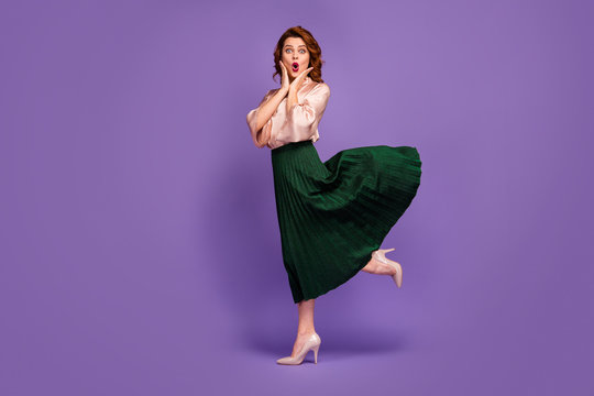 Full length profile side photo of astonished girl go walk see unexpected discount impressed touch hands face scream wow omg wear trend outfit stilettos isolated over purple color background