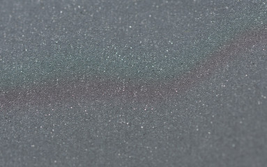 Gray clothing reflective tape. Close-up, selective focus. Highly reflective stripes for high visibility clothing in dark time.