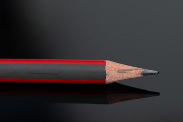Red gray pencil in high resolution isolated on  black background 