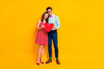 Full size photo comfort couple enjoy 14-february date hold red paper card heart hug tender wear dotted dress mini short legs high-heels suspenders socks isolated bright shine color background
