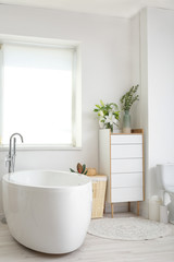Interior of modern bathroom with floral decor