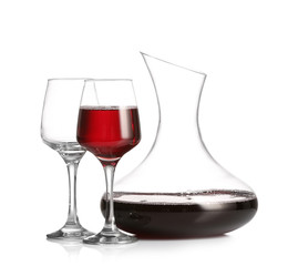 Decanter of wine and glasses on white background