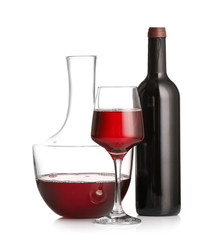 Decanter, glass and bottle of wine on white background
