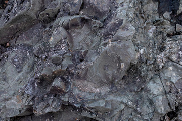 major stone texture and background. Quarry overgrown with moss