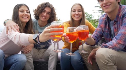 Group of friends having a drink together, celebrating end of school year