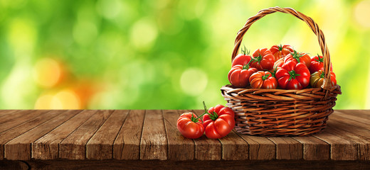 Freshly tomatoes in a basket on a wooden table