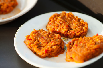 Barbecue and homemade food concept.   Burger cutlet for grill on the white plate. Close up. Space for a text. 