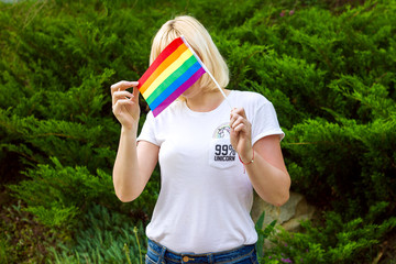 Rainbow LGBT flag in the hands of a girl, concept of gender equality. Lesbian and gay...