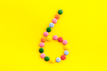 Candies font. Number 6 - six - on yellow background top view