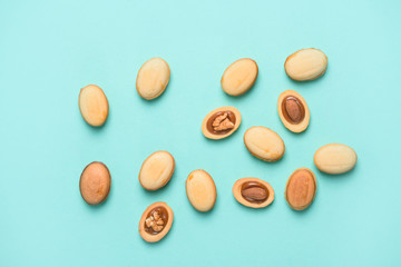 Homemade nuts with condensed milk, chocolate inside, walnuts and almonds. Nuts on a light blue background. A place for text. Flat lay