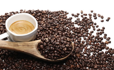 Cup of coffee with beans and wooden spoon  isolated on white background
