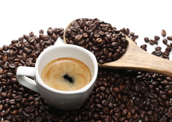 Cup of coffee with beans and wooden spoon  isolated on white background